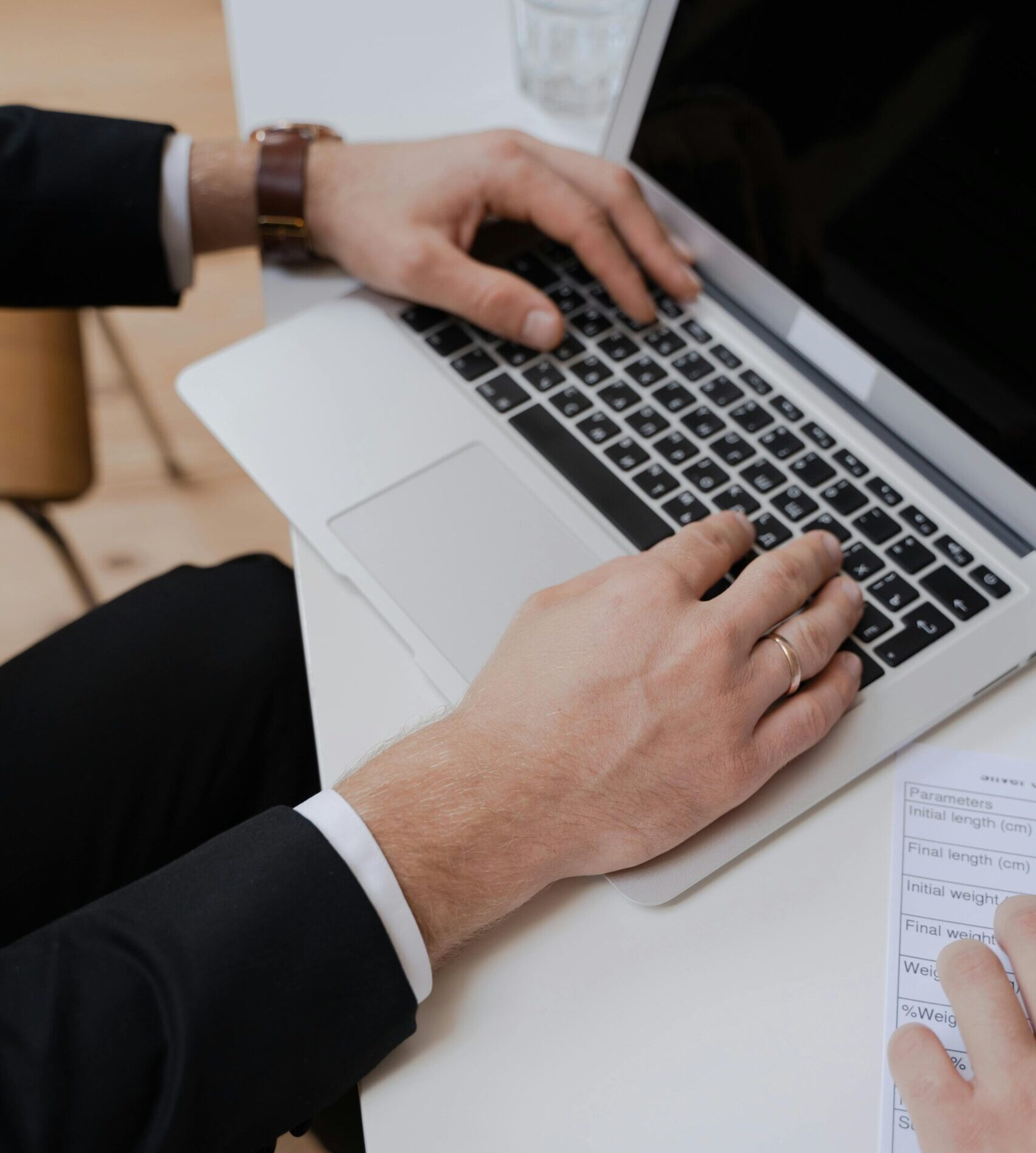 man's hands on his laptop