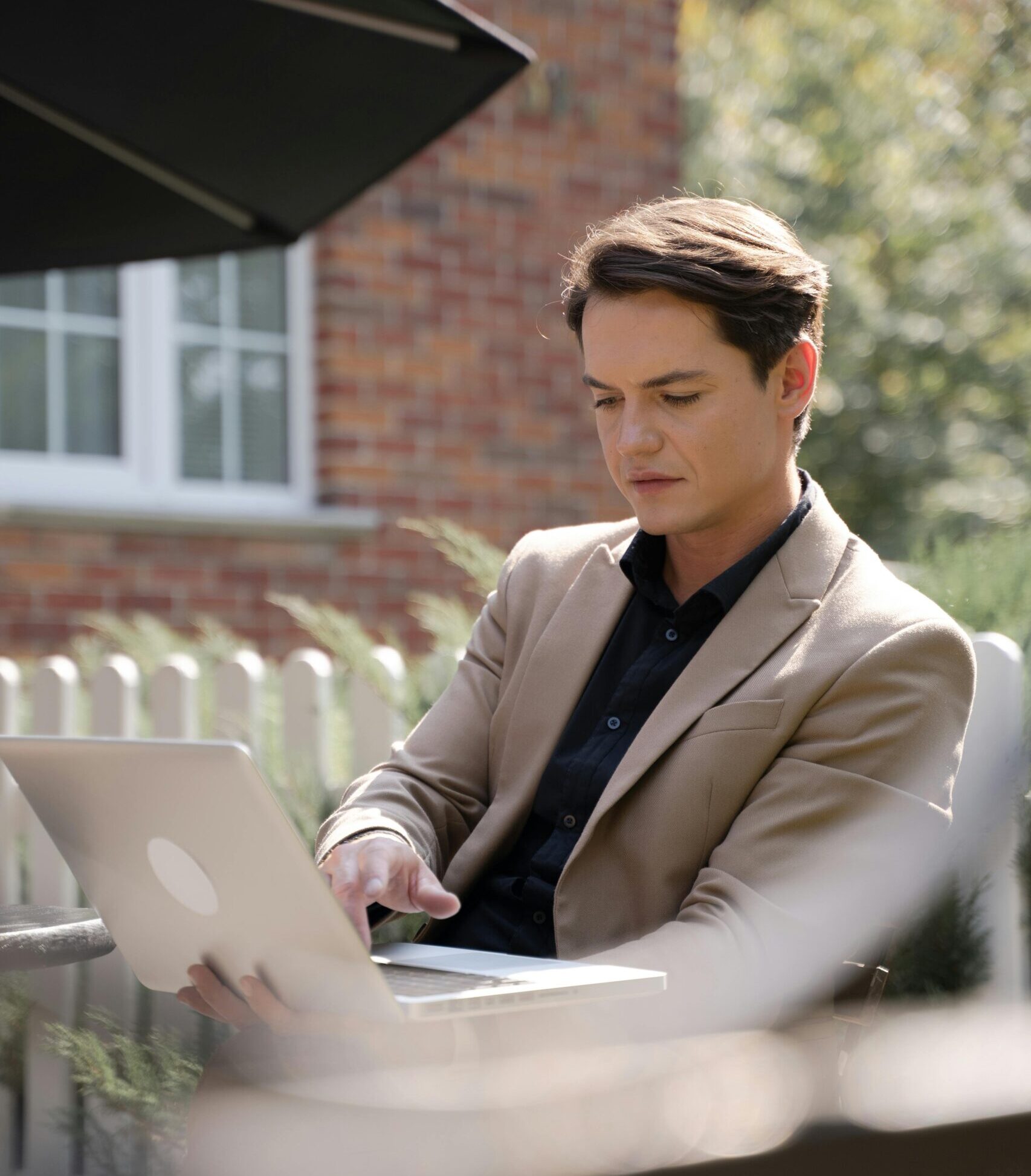 man sitting outside with his laptop